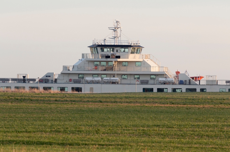 SAMSØ appears behind a field at the new Ballen ferry harbour.